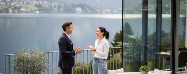 Agent immobilier présentant une villa suisse avec vue sur le lac à des clients